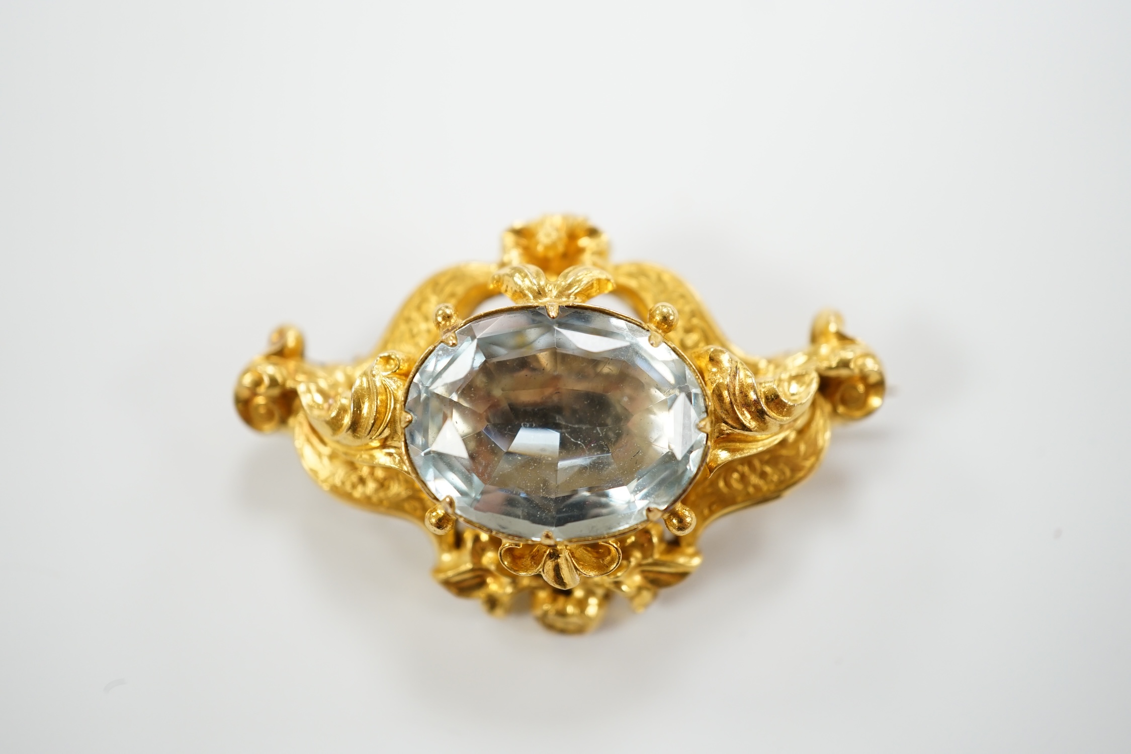 A Victorian yellow metal (tests as 15ct gold) and single stone oval cut aquamarine set brooch, 38mm, gross weight 7.1 grams.